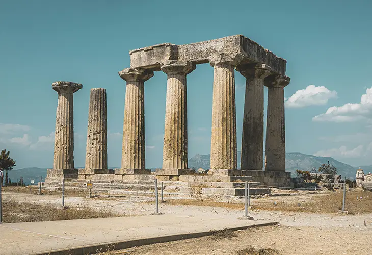 Seven white pillars at the ruins of the temple of Apollo in ancient Corinth
