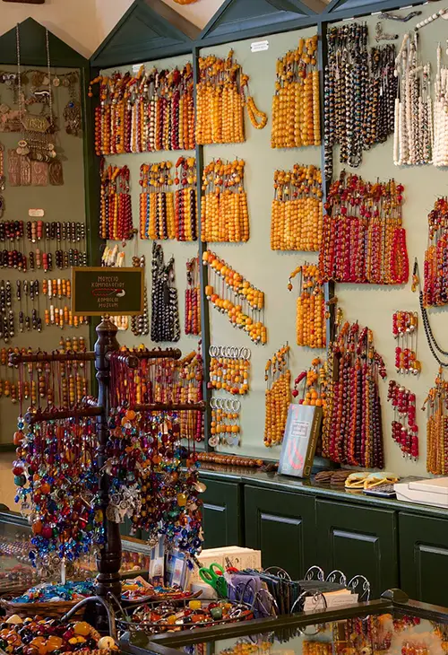 A wall in the Komboloi Museum in Nafplio covered in worry-beads in hues of golden and red